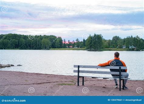 Jeune Homme S Asseyant Sur Le Banc Par Le Lac Image Stock Image Du