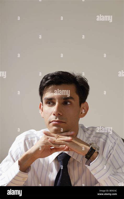 A Man Sits With His Head Resting On His Hands Stock Photo Alamy