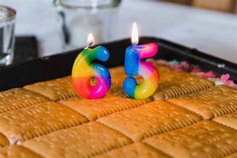 Birthday Cake For 65th Birthday With Candles On Top Stock Photo