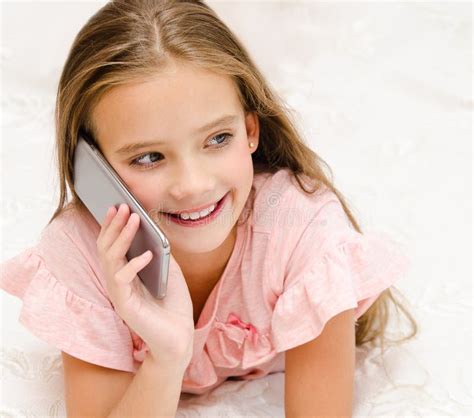 Portrait Of Cute Smiling Little Girl Child Calling By Cell Phone