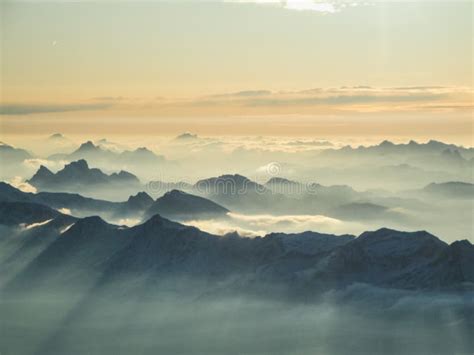 Amazing Aerial View Of Misty Swiss Alps And Clouds Above The Mountain