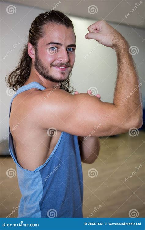 Portrait Of Smiling Man Flexing His Bicep Stock Image Image Of