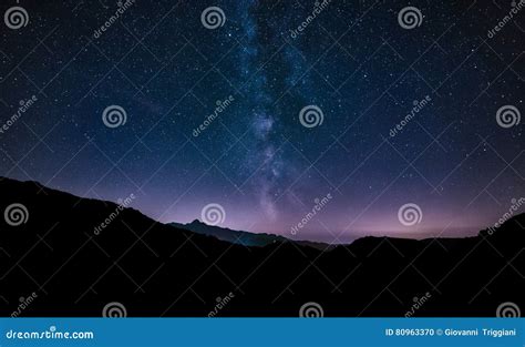 Purple Night Sky Stars Milky Way Galaxy Across Mountains Stock Photo