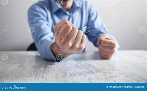 Businessman Hits The Table With His Fists Concept Of Anger Stock Photo