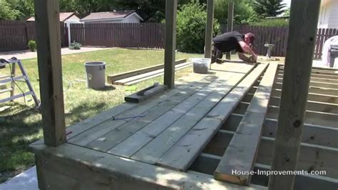 Rest bearers on posts, making sure they line up to your outside building line. How To Build A Deck | #3 Decking [Posts/Border/Decking ...