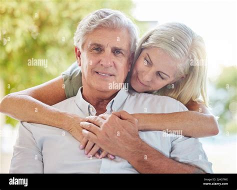 A Happy Mature Caucasian Couple Embracing And Showing Love While Relaxing Together At Home