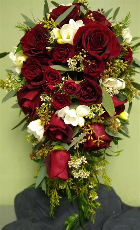 Our bouquets are not that costly, coz currently, we take local orders only(of bouquets). Red Rose Cascading Bouquet with a touch of white ...