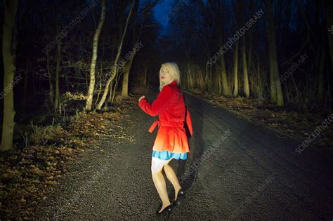 Woman running in fear in woods at night - Stock Image - F005/2808