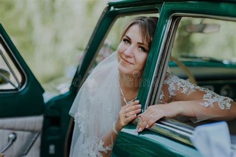 wedding bride rest and have fun on green vintage retro car after wedding honeymoon concept car