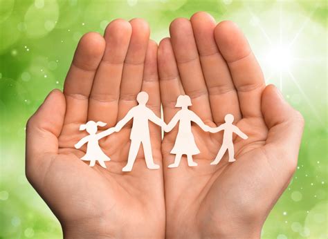 Family. Paper chain family protected in cupped hands - Pathway for