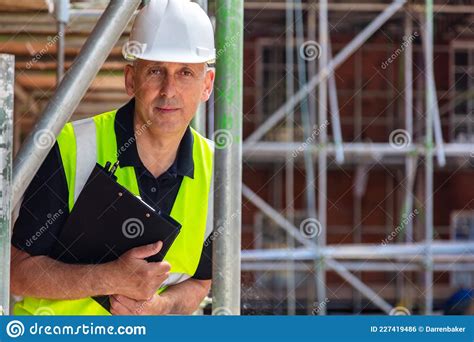 Serious Male Builder Architect Contractor On Building Site Wearing A