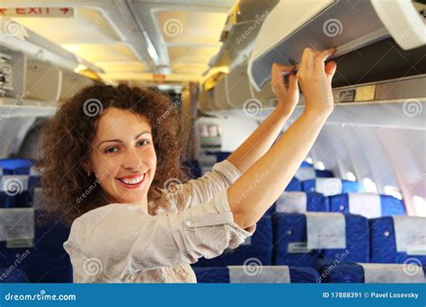 Woman On Airplane Adds Baggage Stock Image Image Of Interior Blue
