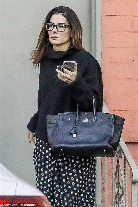 Sandra Bullock Stays Warm In Black Mock Neck Sweater And Long Patterned
