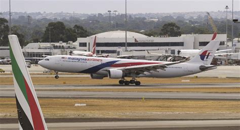 malaysia airlines flight mh148 makes emergency landing in australia after possible engine fire