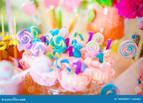 Pink And Blue Cupcakes With Colored Lollypops For Candy Bar Stock Photo