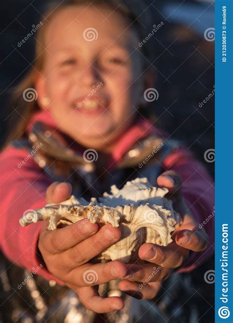 A Girl Holds A White Seashell In Her Hands Stock Image Image Of Hand