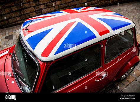 A Red Mini Cooper And Closeup Wth A Union Jack Roof By John Cooper