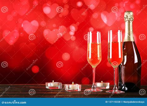 Champagne For Couple In Love In Two Flutes On Table With Red Tablecloth