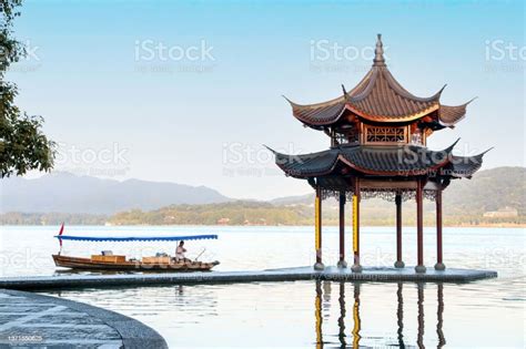 Beautiful Landscape At Hangzhou West Lake As A Rowing Boat Rows Passed