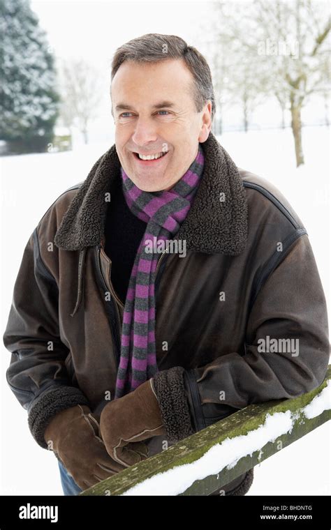 Senior Man Standing Outside In Snowy Landscape Stock Photo Alamy