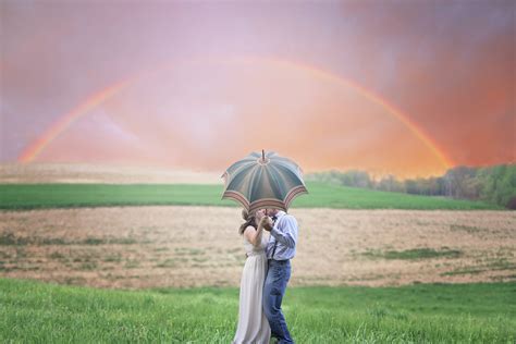 Download Couple In Love Kissing Under An Umbrella Wallpaper