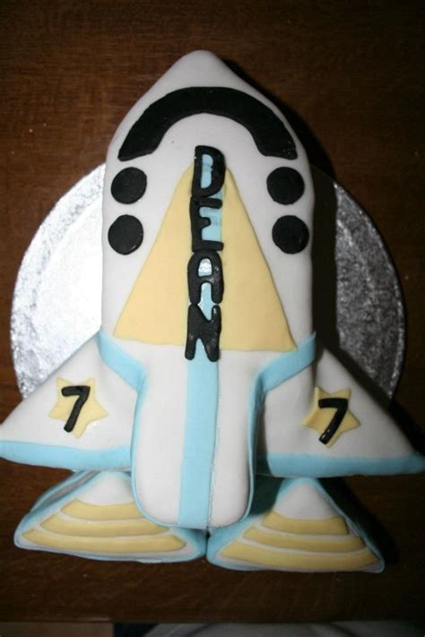 I used the scrap pieces to make the shuttle taller and then used a potato peeler to shave the nose into the. Space shuttle cake