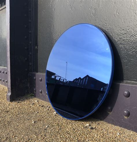 Delightful Blue Tinted Round Mirror With A Smart Blue Frame Designed