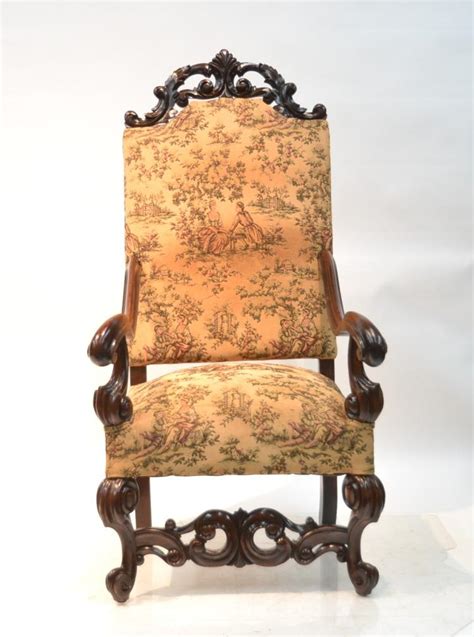 High quality victorian club chair , solid mahogany frame, hand caved with floral bouquets, re velvet upholstery. UPHOLSTERED MAHOGANY THRONE CHAIR WITH CARVED