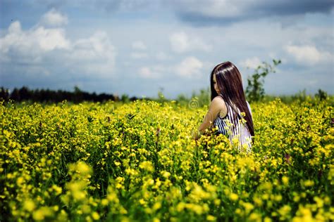 Happy Woman Sitting On Yellow Sunny Flowers Field Stock Image Image