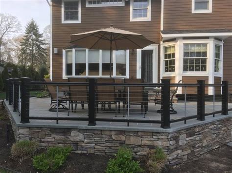 My philosophy has always been, if. A beautiful composite post and cable rail fence on blue ...