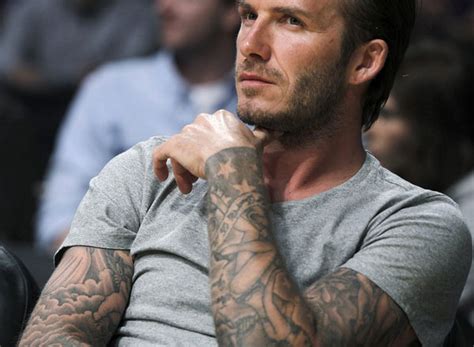 The main tattoo on the forearm is a giant angel sentinel, holding a flame in her hand so that her face is. 20 Super-Sexy David Beckham Tattoos - SloDive