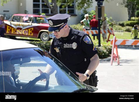 Policeman talking with a driver about a traffic violation Stock Photo