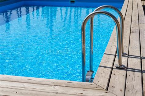 Steel Ladder Stairs Into Blue Outdoor Skimmer Pool Wooden Floor Stock