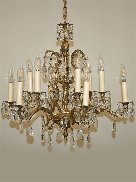Spanish baroque style chandelier, probably made in the 1930's. Vintage Spanish Cast 12 Light Brass & Crystal Chandelier w ...