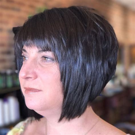 Short Black Angled Bob With Choppy Layers And Choppy Brow Skimming Bangs The Latest Hairstyles
