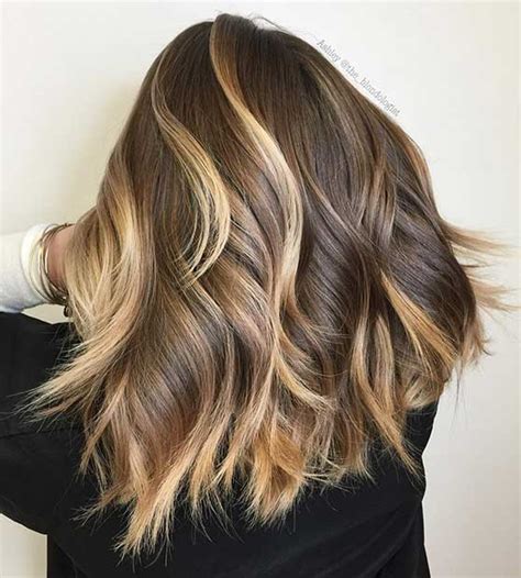 The wavy brown hair that's styled with a dash of blonde and just a bit of red will make heads turn for sure. 47 Stunning Blonde Highlights for Dark Hair | StayGlam