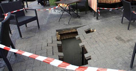 Sinkhole Swallows Woman After Gaping Hole In Pavement Opens Up