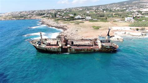 Video From Above Aerial View Of Sea Coast Flying Over Coastline With Broken Ship