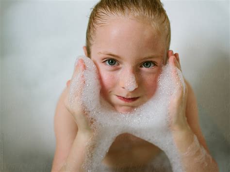 A Little Girl Goofing Around In A Bubble Bath By Stocksy Contributor