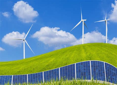 Photovoltaics Solar Panels And Wind Turbines On Green Field Stock Image