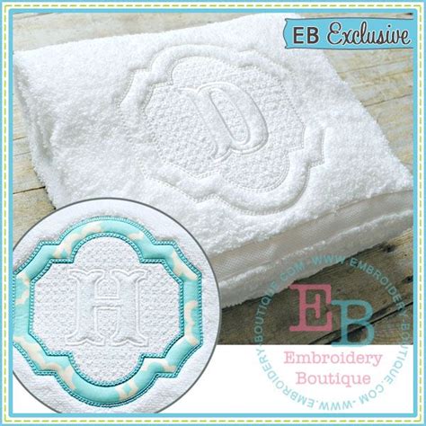 An Embroidered Monogrammed Towel With The Letter Eb On It