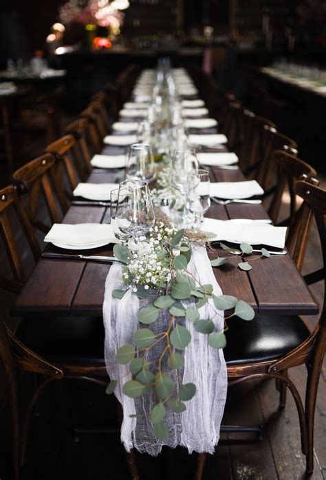 Table Decor Featuring Lose Greenery Placed In Garland Style With Baby