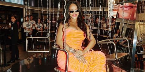 Rihanna Wearing Orange Dress While Sitting On A Carousel Popsugar Fashion
