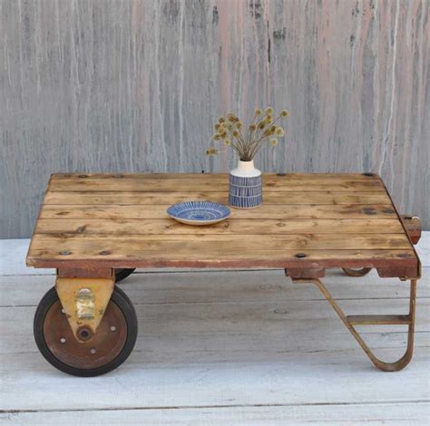 The table is fabricated from an old wooden pallet and stamped with norfolk & western ry graphics to resemble an old industrial cart. Vintage Rustic Factory Small Industrial Cart Coffee Table
