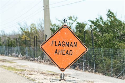 Flagman Ahead Traffic Road Sign In Red Orange Color Signal For Drivers