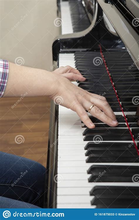 Closeup Of The Hands Of A Young Woman Playing The Piano