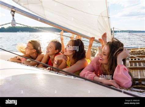 Four Young Women Relaxing On A Sailing Yacht Stock Photo Alamy