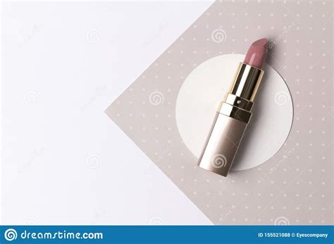 Nude Pink Lipstick On Creative Polka Dot Beige Background With Copy