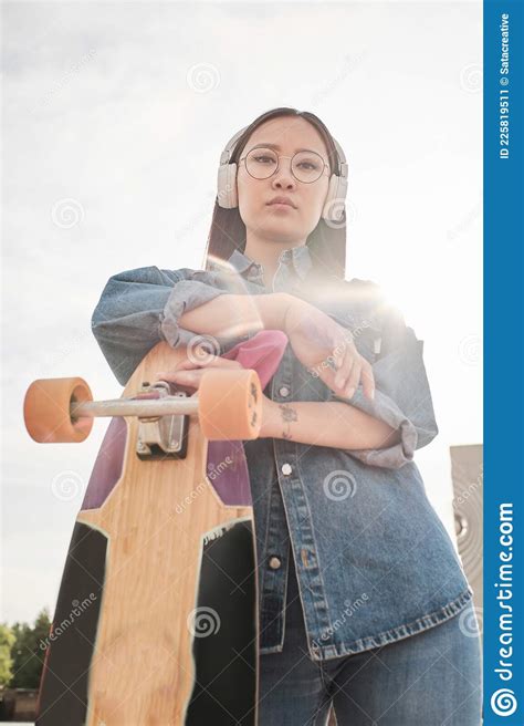 Girl In Glasses Stands Outside With A Skateboard Stock Image Image