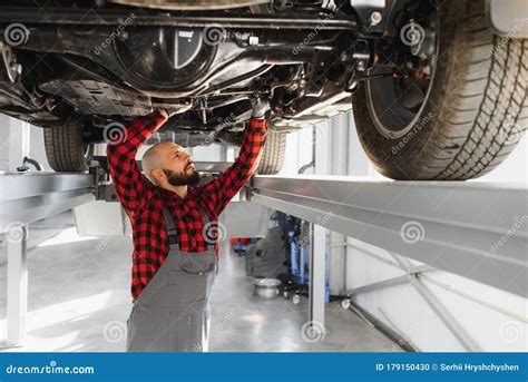 Mechanic Working Under Car At The Repair Garage Auto Mechanic Working